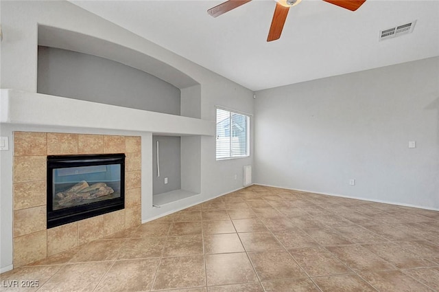 1574 Ward Frontier Ln, Henderson, NV 89002 - unfurnished living room with ceiling fan, a tiled fireplace, baseboards, and tile patterned flooring
