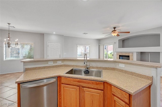 1574 Ward Frontier Ln, Henderson, NV 89002 - kitchen featuring dishwasher, a sink, open floor plan, light tile patterned floors, and light countertops