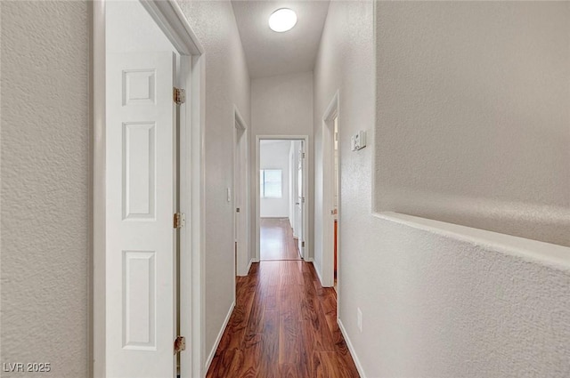 1574 Ward Frontier Ln, Henderson, NV 89002 - hallway with dark wood-style flooring, a textured wall, and baseboards