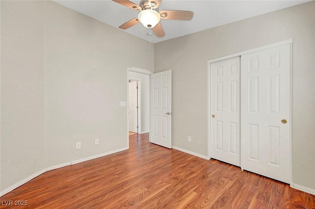1574 Ward Frontier Ln, Henderson, NV 89002 - unfurnished bedroom featuring wood finished floors, baseboards, a closet, vaulted ceiling, and a ceiling fan