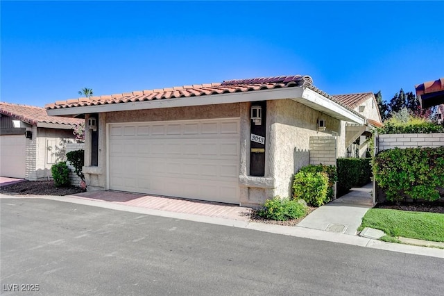 3013 Plaza De Rosa, Las Vegas, NV 89102 - view of front of house with stucco siding, a garage, and a tiled roof