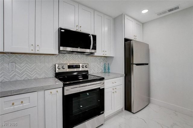 3013 Plaza De Rosa, Las Vegas, NV 89102 - kitchen with stainless steel appliances, white cabinets, baseboards, decorative backsplash, and light countertops