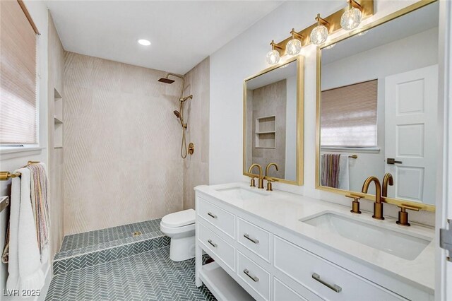 3013 Plaza De Rosa, Las Vegas, NV 89102 - full bathroom featuring toilet, tiled shower, double vanity, tile patterned flooring, and recessed lighting