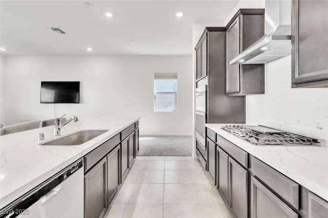 1596 Pacific Baza St, Las Vegas, NV 89138 - kitchen featuring a sink, appliances with stainless steel finishes, light colored carpet, wall chimney exhaust hood, and light stone counters