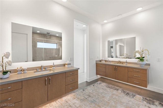 826 Bolide St, Las Vegas, NV 89138 - bathroom featuring two vanities, a shower stall, baseboards, and recessed lighting