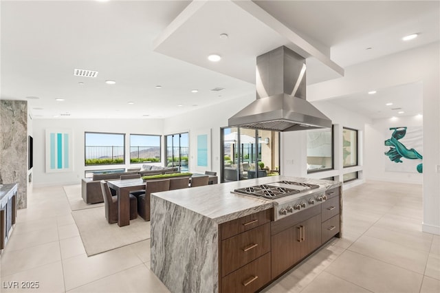 826 Bolide St, Las Vegas, NV 89138 - kitchen featuring a large island, island exhaust hood, stainless steel gas cooktop, light tile patterned floors, and recessed lighting