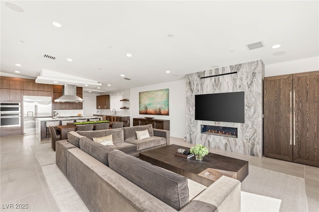 826 Bolide St, Las Vegas, NV 89138 - living room with recessed lighting, a fireplace, and light tile patterned floors