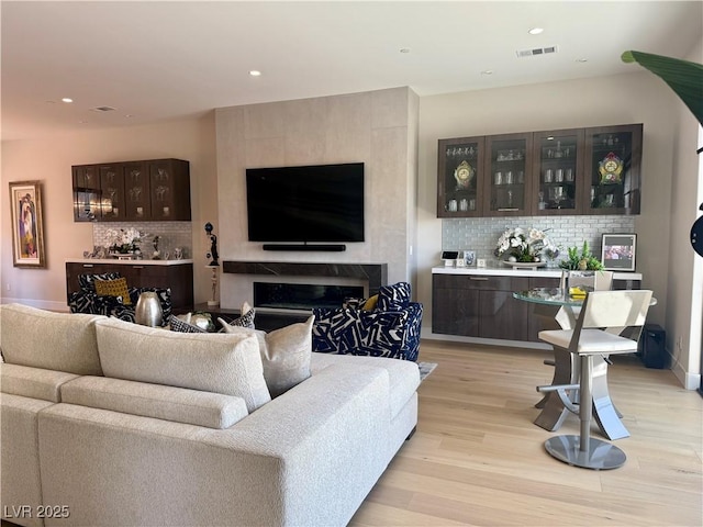 358 Solitude Peak Ln, Henderson, NV 89012 - living area with light wood-type flooring, recessed lighting, and a high end fireplace