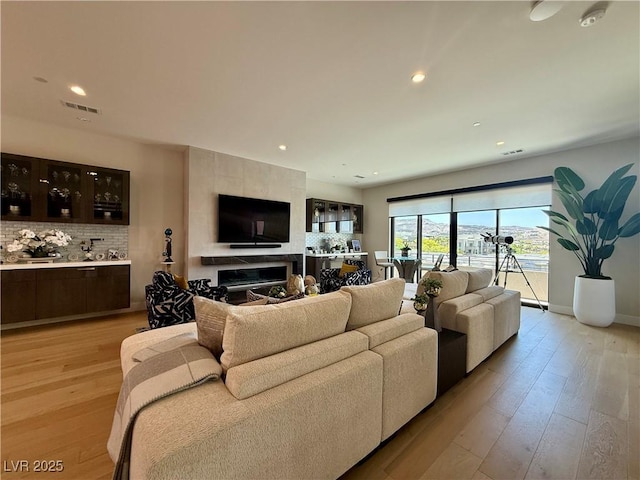 358 Solitude Peak Ln, Henderson, NV 89012 - living room with light wood finished floors, recessed lighting, a fireplace, and baseboards