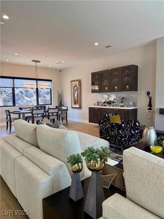 358 Solitude Peak Ln, Henderson, NV 89012 - living room with wood finished floors, baseboards, and recessed lighting