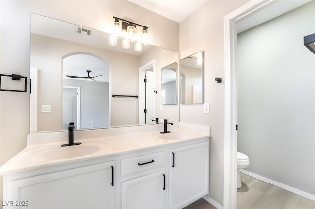 6260 Castle Kennedy St, Henderson, NV 89011 - full bathroom with double vanity, ceiling fan, toilet, and baseboards