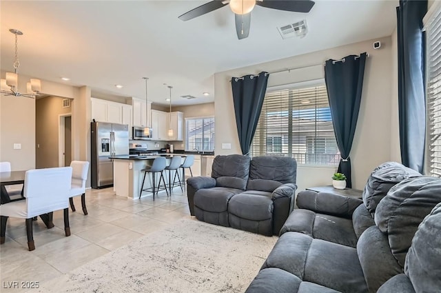 8490 Classique Ave Unit 101, Las Vegas, NV 89178 - living room featuring light tile patterned floors, a ceiling fan, a chandelier, and recessed lighting