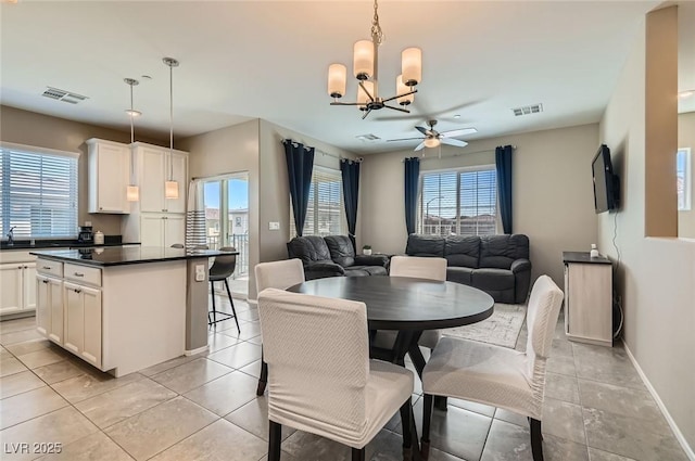 8490 Classique Ave Unit 101, Las Vegas, NV 89178 - dining area featuring a chandelier, baseboards, ceiling fan, and light tile patterned floors