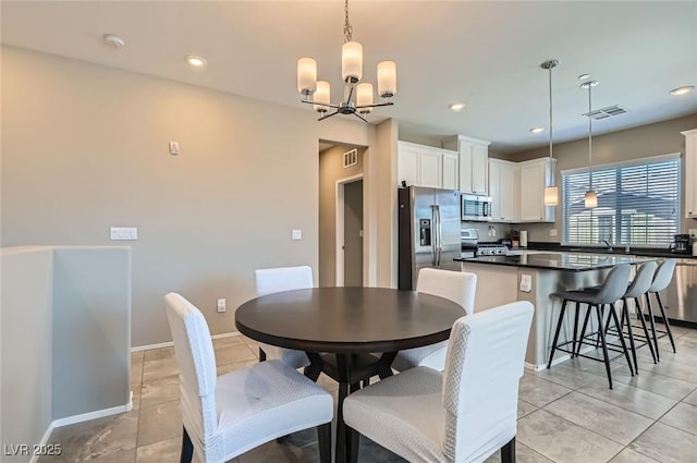 8490 Classique Ave Unit 101, Las Vegas, NV 89178 - dining room featuring a chandelier, recessed lighting, baseboards, and light tile patterned floors
