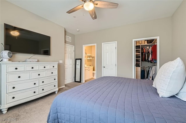 8490 Classique Ave Unit 101, Las Vegas, NV 89178 - carpeted bedroom with a walk in closet, a ceiling fan, a closet, and ensuite bathroom