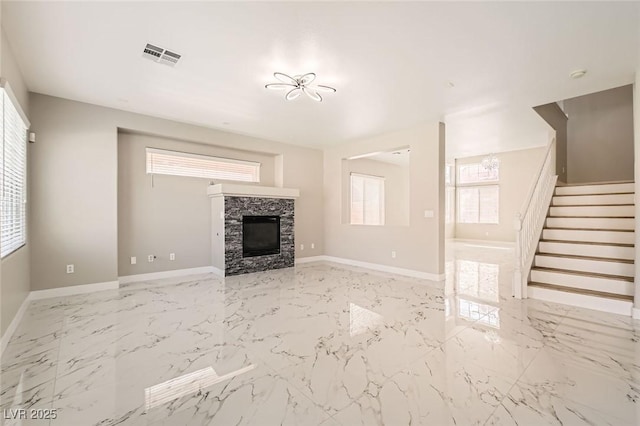 216 Sharp Edge Ave, North Las Vegas, NV 89031 - unfurnished living room featuring stairs, marble finish floors, a stone fireplace, and baseboards