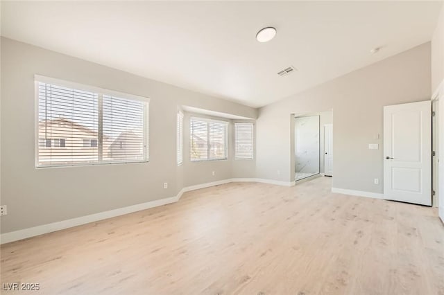 216 Sharp Edge Ave, North Las Vegas, NV 89031 - unfurnished bedroom featuring lofted ceiling, light wood finished floors, and baseboards