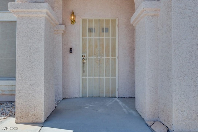 1551 Echo Falls Ave, Las Vegas, NV 89183 - doorway to property featuring stucco siding and a patio area