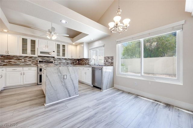 1551 Echo Falls Ave, Las Vegas, NV 89183 - kitchen with stainless steel appliances, backsplash, plenty of natural light, white cabinetry, and recessed lighting