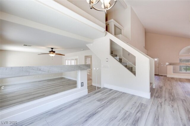 1551 Echo Falls Ave, Las Vegas, NV 89183 - unfurnished living room with stairway, light wood finished floors, a ceiling fan, a chandelier, and baseboards