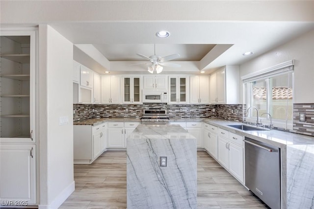 1551 Echo Falls Ave, Las Vegas, NV 89183 - kitchen featuring appliances with stainless steel finishes, a sink, ceiling fan, light stone counters, and white cabinetry