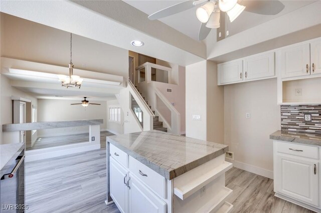 1551 Echo Falls Ave, Las Vegas, NV 89183 - kitchen with a ceiling fan, open shelves, light wood finished floors, backsplash, and white cabinetry