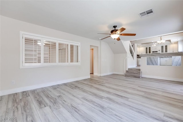1551 Echo Falls Ave, Las Vegas, NV 89183 - unfurnished living room with ceiling fan, a chandelier, light wood-style flooring, and baseboards