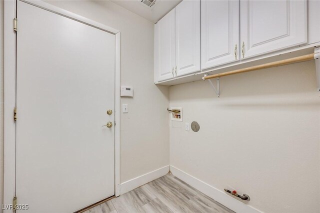 1551 Echo Falls Ave, Las Vegas, NV 89183 - washroom featuring hookup for a gas dryer, baseboards, hookup for a washing machine, cabinet space, and light wood-style flooring
