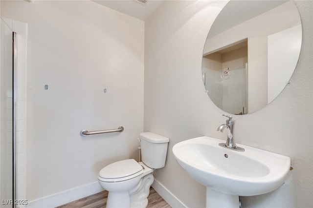 1551 Echo Falls Ave, Las Vegas, NV 89183 - full bathroom featuring a sink, toilet, wood finished floors, and baseboards