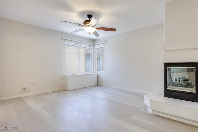 1551 Echo Falls Ave, Las Vegas, NV 89183 - unfurnished living room with ceiling fan, a tile fireplace, and baseboards
