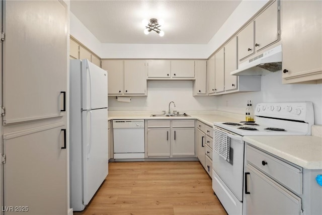 3151 Soaring Gulls Dr Unit 2121, Las Vegas, NV 89128 - kitchen featuring white appliances, under cabinet range hood, a sink, light wood-type flooring, and light countertops