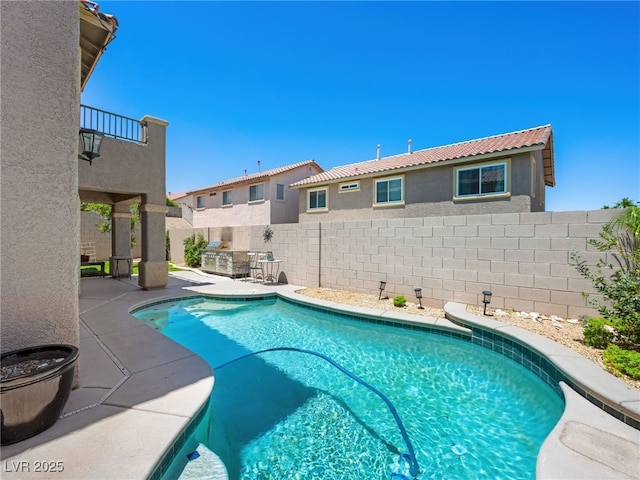 10612 Gum Tree Ct, Las Vegas, NV 89144 - view of pool featuring a patio, a fenced backyard, and an outdoor kitchen