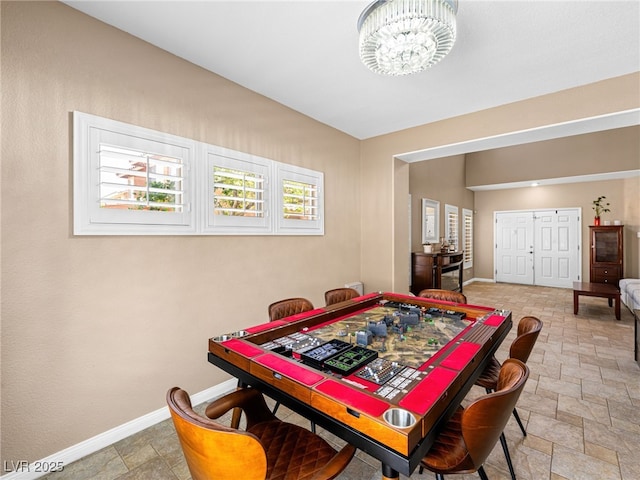 10612 Gum Tree Ct, Las Vegas, NV 89144 - playroom with baseboards, a chandelier, and stone finish floors