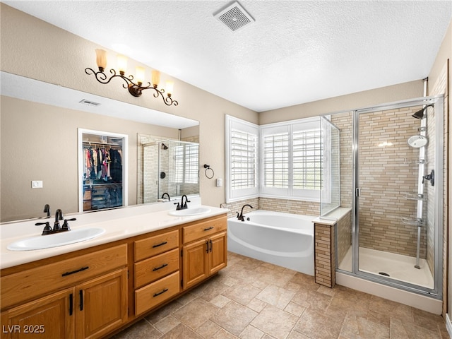 10612 Gum Tree Ct, Las Vegas, NV 89144 - full bath featuring a garden tub, a stall shower, a textured ceiling, double vanity, and a walk in closet