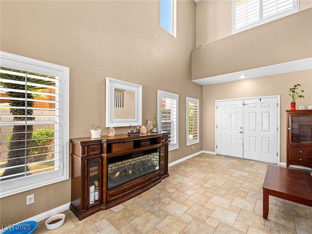 10612 Gum Tree Ct, Las Vegas, NV 89144 - entrance foyer with baseboards, healthy amount of natural light, a towering ceiling, and light stone finish floors
