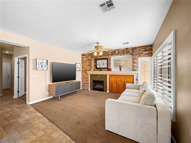 10612 Gum Tree Ct, Las Vegas, NV 89144 - living room featuring stone finish floors, a ceiling fan, baseboards, and a fireplace
