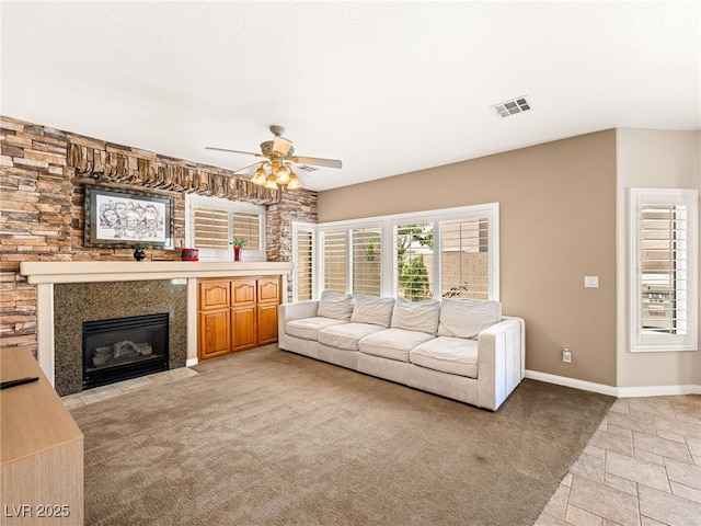 10612 Gum Tree Ct, Las Vegas, NV 89144 - living area featuring a ceiling fan, a fireplace with flush hearth, light colored carpet, and baseboards