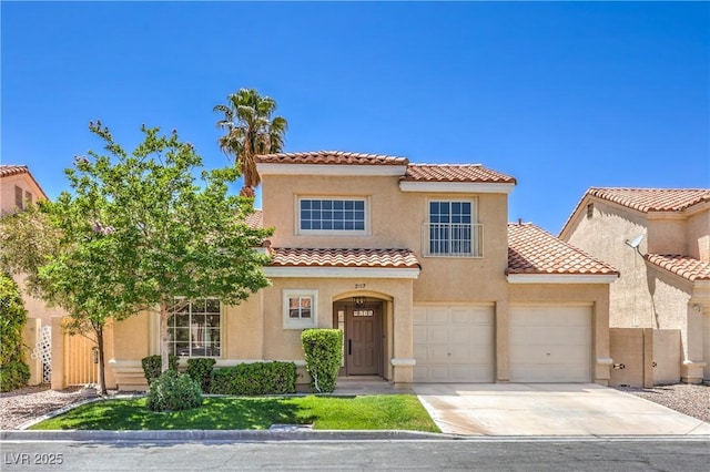2117 Desert Peak Rd, Las Vegas, NV 89134 - mediterranean / spanish house featuring a tiled roof, concrete driveway, stucco siding, and an attached garage