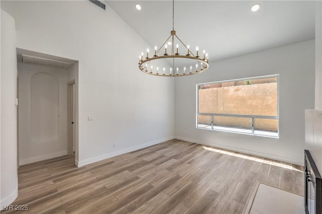 2117 Desert Peak Rd, Las Vegas, NV 89134 - unfurnished dining area featuring a chandelier, wood finished floors, baseboards, recessed lighting, and high vaulted ceiling