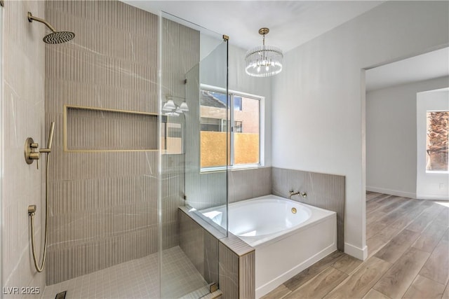 2117 Desert Peak Rd, Las Vegas, NV 89134 - bathroom with a shower stall, a garden tub, wood finished floors, and a chandelier