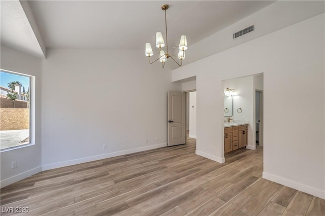 2117 Desert Peak Rd, Las Vegas, NV 89134 - empty room with a chandelier, light wood finished floors, baseboards, and a sink