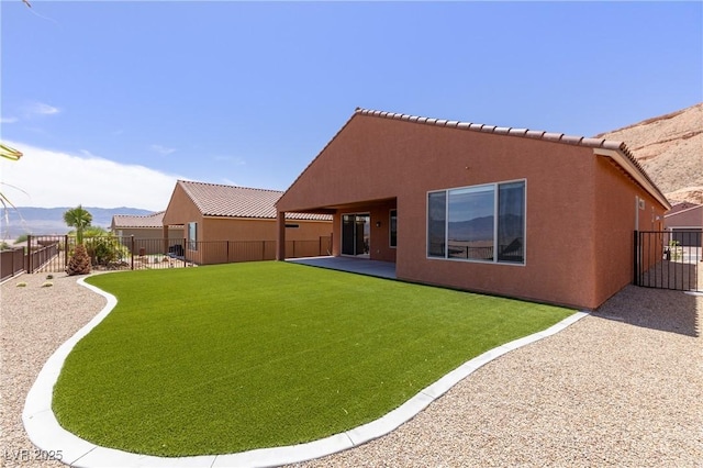 1398 Pin Cushion Rdg, Mesquite, NV 89034 - back of house with stucco siding, a fenced backyard, a mountain view, and a patio