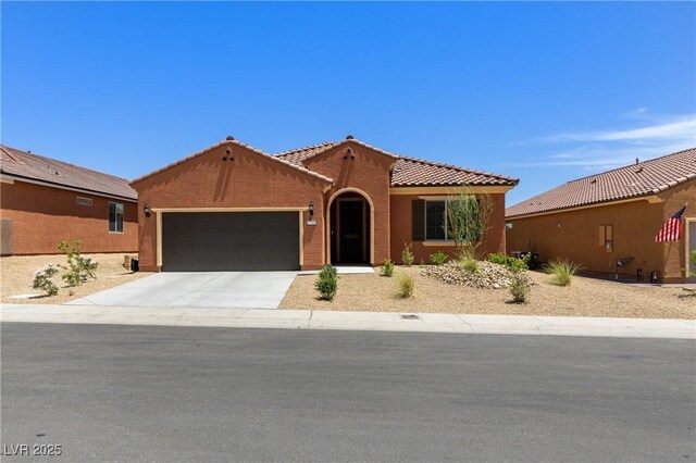 1398 Pin Cushion Rdg, Mesquite, NV 89034 - mediterranean / spanish home with a garage, a tile roof, concrete driveway, and stucco siding
