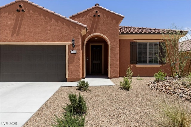 1398 Pin Cushion Rdg, Mesquite, NV 89034 - mediterranean / spanish-style house with stucco siding, a garage, concrete driveway, and a tiled roof