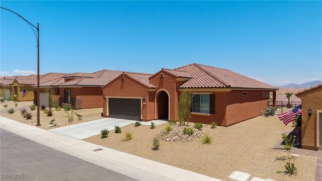 1398 Pin Cushion Rdg, Mesquite, NV 89034 - view of front facade with a tiled roof, stucco siding, a garage, and driveway