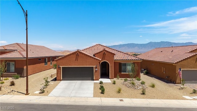 1398 Pin Cushion Rdg, Mesquite, NV 89034 - view of front of property featuring a garage, a mountain view, concrete driveway, a tile roof, and stucco siding