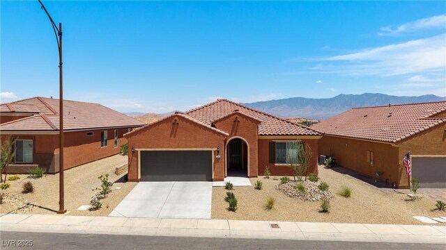 1398 Pin Cushion Rdg, Mesquite, NV 89034 - view of front of property featuring a garage, a mountain view, concrete driveway, a tile roof, and stucco siding