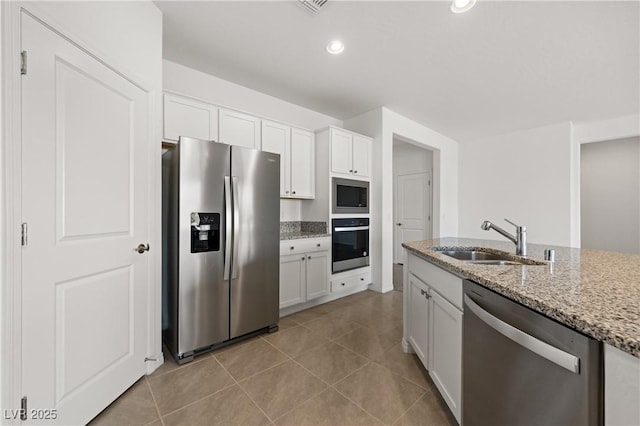 1398 Pin Cushion Rdg, Mesquite, NV 89034 - kitchen with appliances with stainless steel finishes, white cabinetry, light stone countertops, light tile patterned floors, and recessed lighting