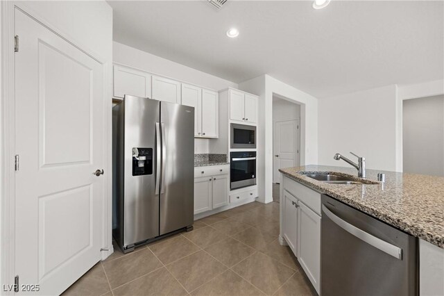 1398 Pin Cushion Rdg, Mesquite, NV 89034 - kitchen with appliances with stainless steel finishes, white cabinetry, light stone countertops, light tile patterned floors, and recessed lighting