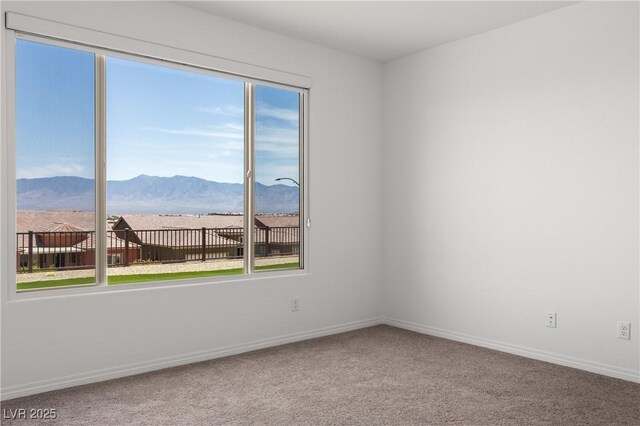 1398 Pin Cushion Rdg, Mesquite, NV 89034 - empty room featuring a mountain view and carpet flooring